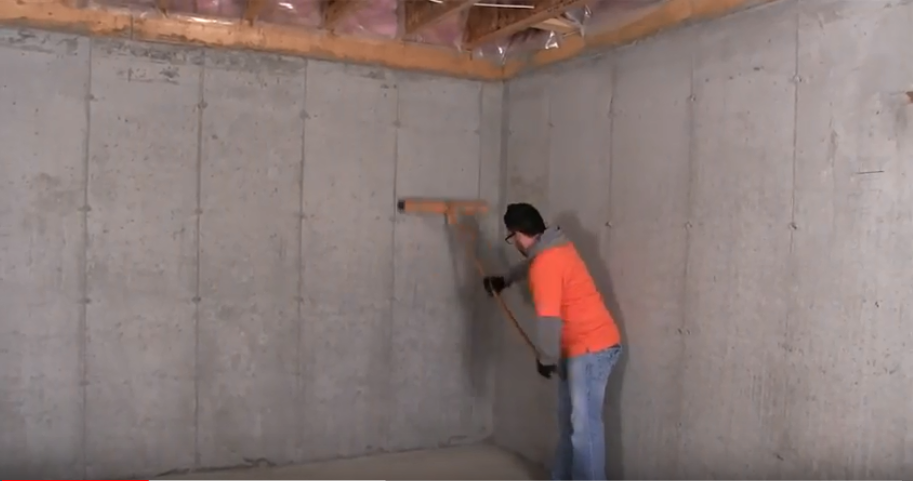 male construction worker cleaning off a concrete wall before installing Halo®